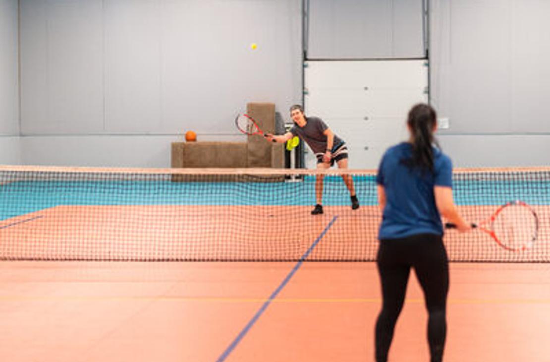 Tenniksen pelaajat liikuntahallilla